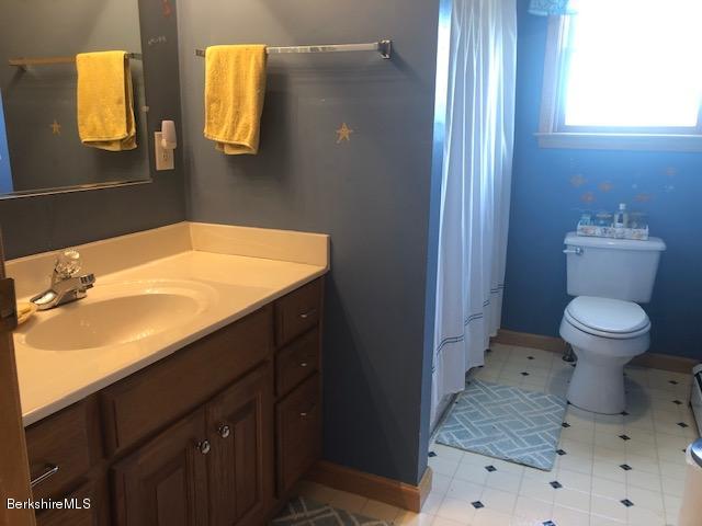 110 Hill Cemetery Road Windsor, MA 01270 - Photo 40 of 52 a bathroom with a sink a toilet and mirror