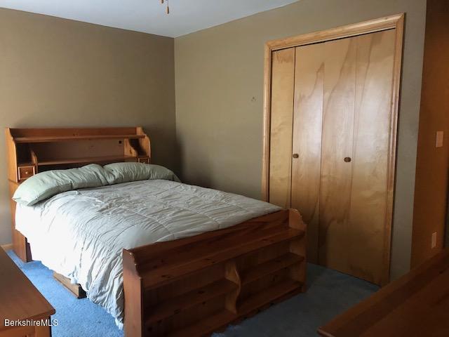 110 Hill Cemetery Road Windsor, MA 01270 - Photo 42 of 52 a bedroom with a bed and a mirror