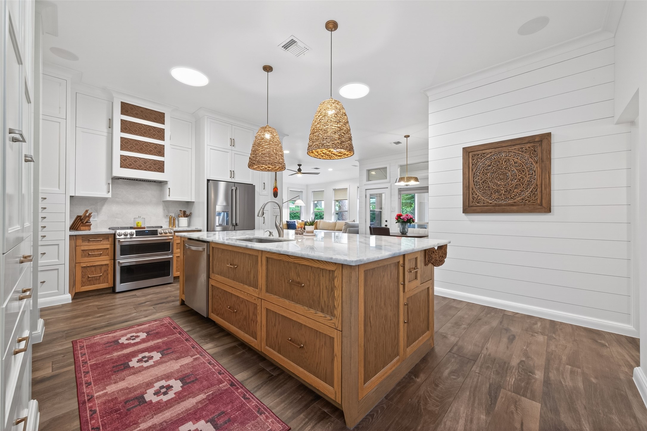 10 Belcarra Place Spring, TX 77382 - Photo 13 of 49 Magnificent huge island kitchen in the center of the home with natural light from 3 large solar tubes, Grand natural stone island with custom wood cabinetry & carved wood accents and amazing, thoughtful conce, drawers and pullouts