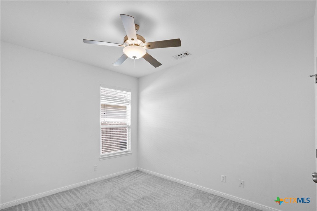 103 Dripping Spring Victoria, TX 77904 - Photo 12 of 27 an empty room with a window and a fan