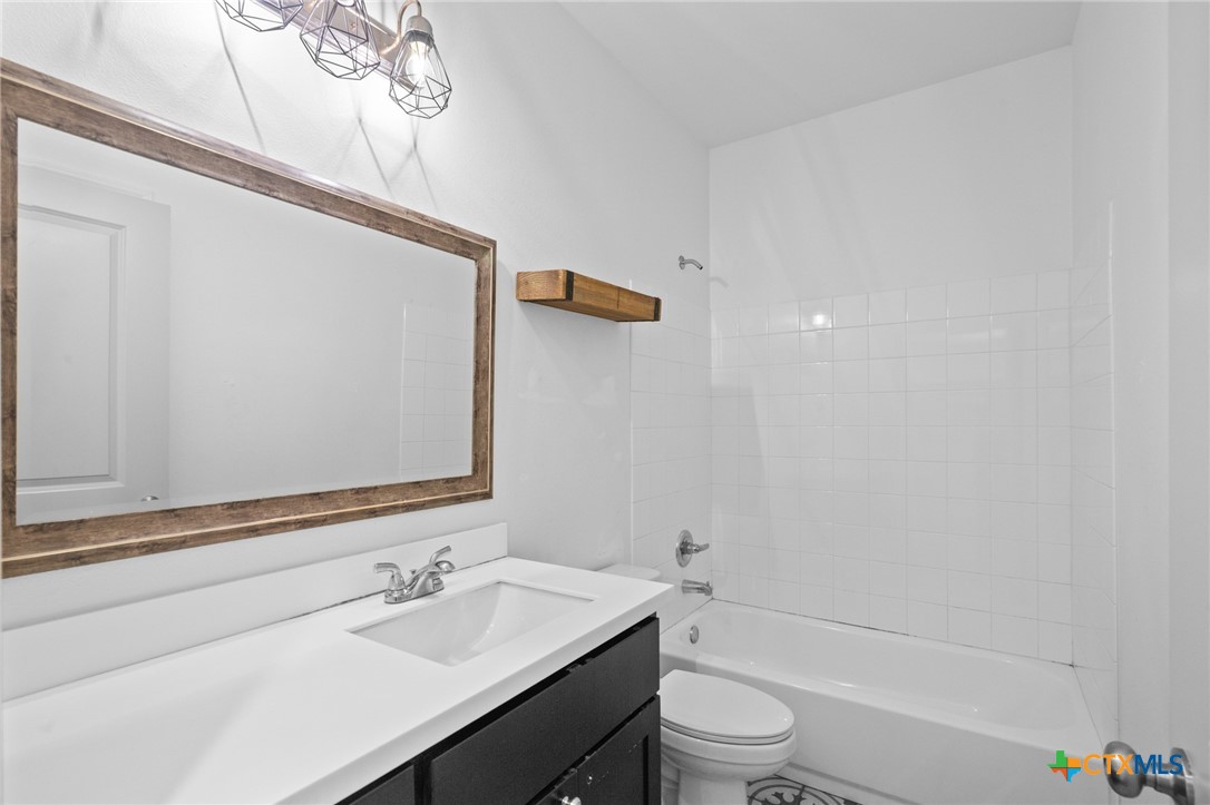 103 Dripping Spring Victoria, TX 77904 - Photo 15 of 27 a bathroom with a sink a toilet a mirror and shower