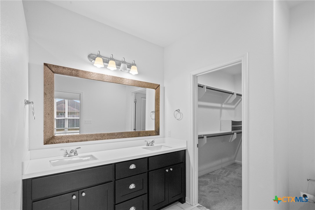 103 Dripping Spring Victoria, TX 77904 - Photo 16 of 27 a bathroom with a double vanity sink and a mirror