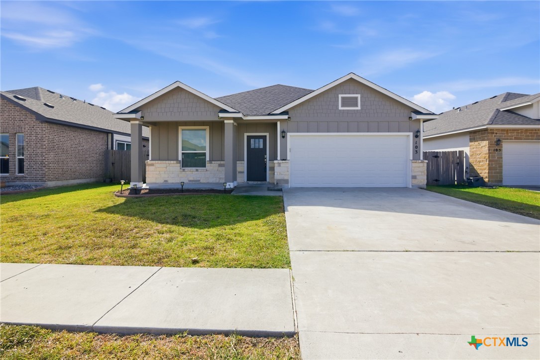 103 Dripping Spring Victoria, TX 77904 - Photo 22 of 27 a view of a house with a yard and garage