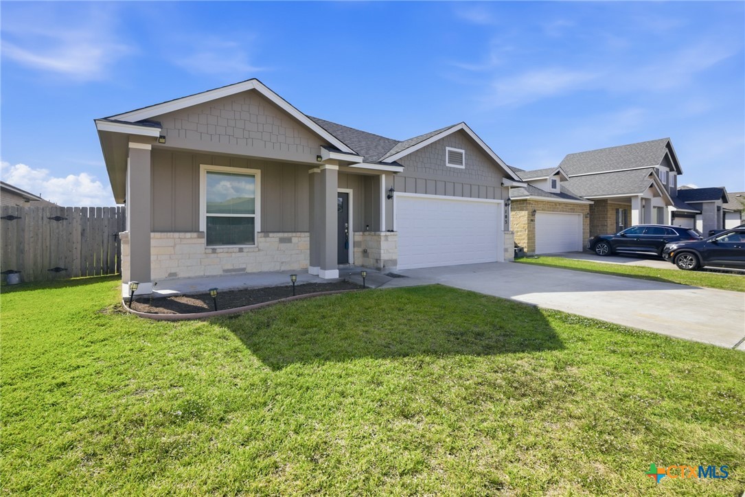 103 Dripping Spring Victoria, TX 77904 - Photo 3 of 27 a front view of a house with a yard and garage