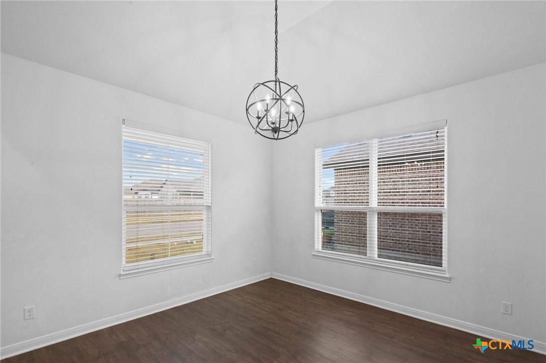 103 Dripping Spring Victoria, TX 77904 - Photo 4 of 27 a view of an empty room with window wooden floor and a kitchen view