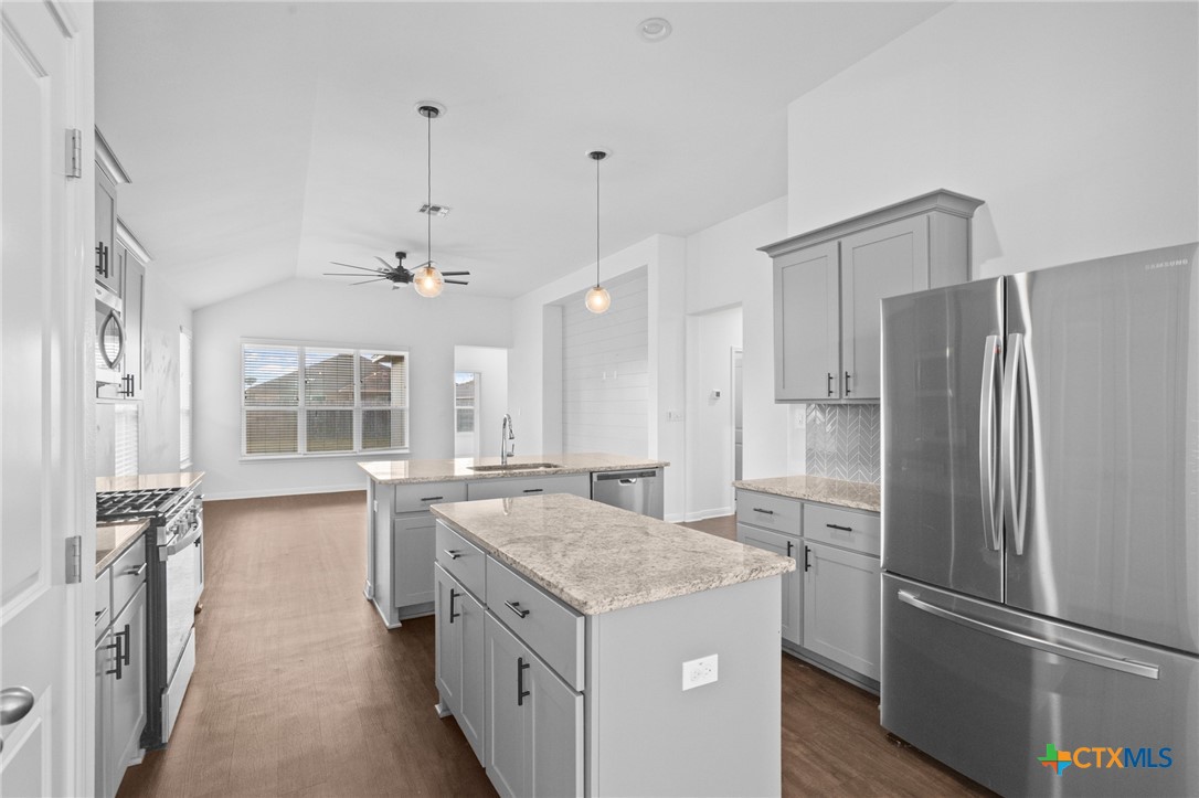 103 Dripping Spring Victoria, TX 77904 - Photo 6 of 27 a kitchen with granite countertop a refrigerator and a sink