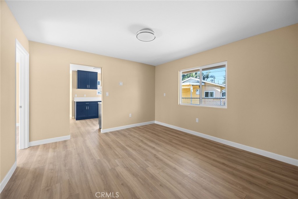 9734 Rio Hondo Parkway El Monte, CA 91733 - Photo 15 of 45 an empty room with wooden floor and windows