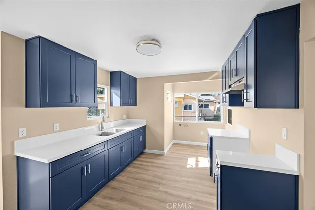a kitchen with a sink and wooden cabinets