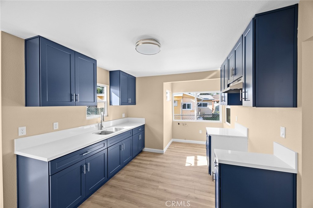 9734 Rio Hondo Parkway El Monte, CA 91733 - Photo 17 of 45 a kitchen with a sink and wooden cabinets