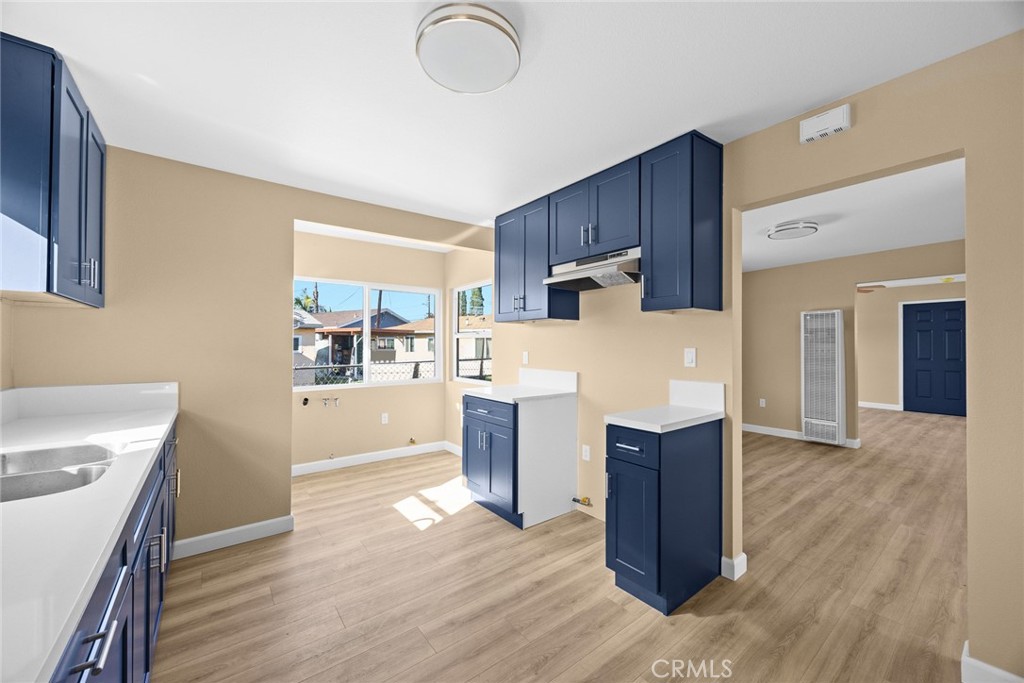 9734 Rio Hondo Parkway El Monte, CA 91733 - Photo 18 of 45 a kitchen with wooden floors and wooden cabinets