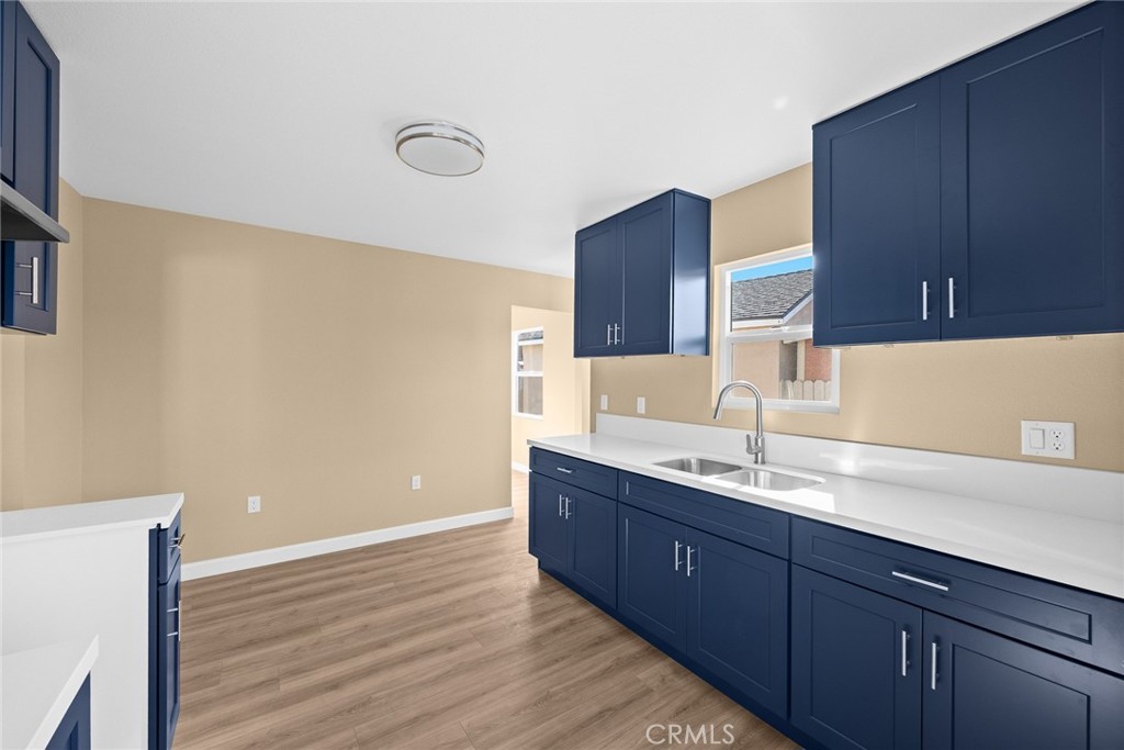 9734 Rio Hondo Parkway El Monte, CA 91733 - Photo 20 of 45 a kitchen with a sink and wooden cabinets