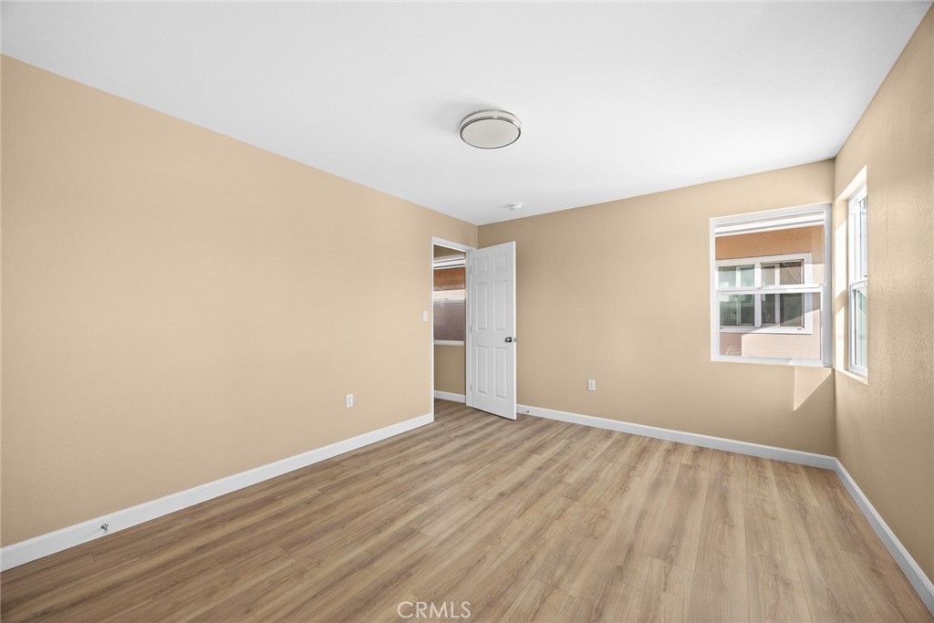 9734 Rio Hondo Parkway El Monte, CA 91733 - Photo 25 of 45 an empty room with wooden floor and windows
