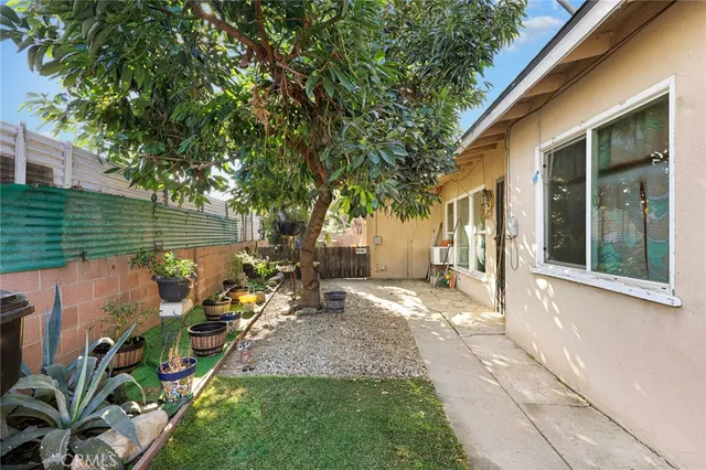 a view of a house with backyard sitting area and garden