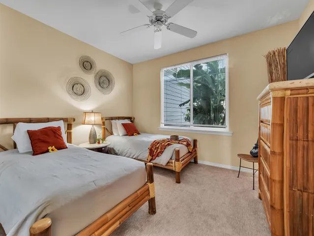 a bedroom with two beds and a window