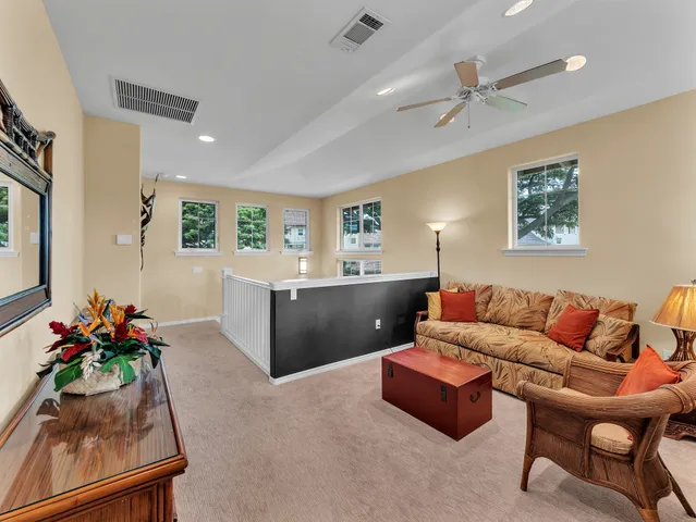 a living room with furniture and flowers