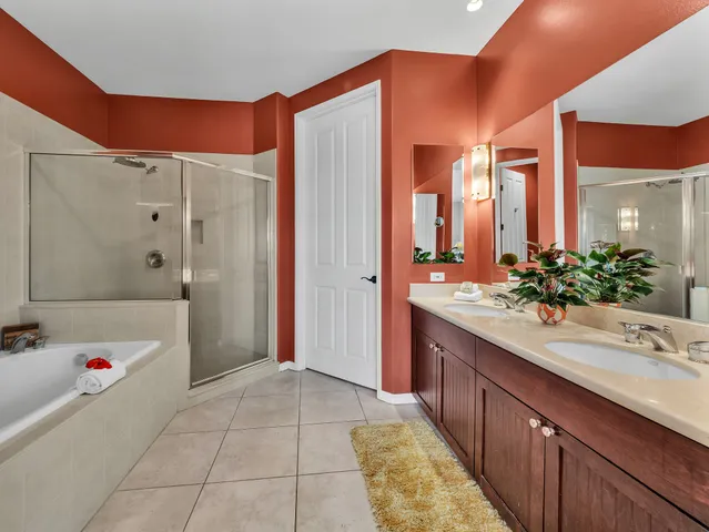 a bathroom with a tub sink and mirror