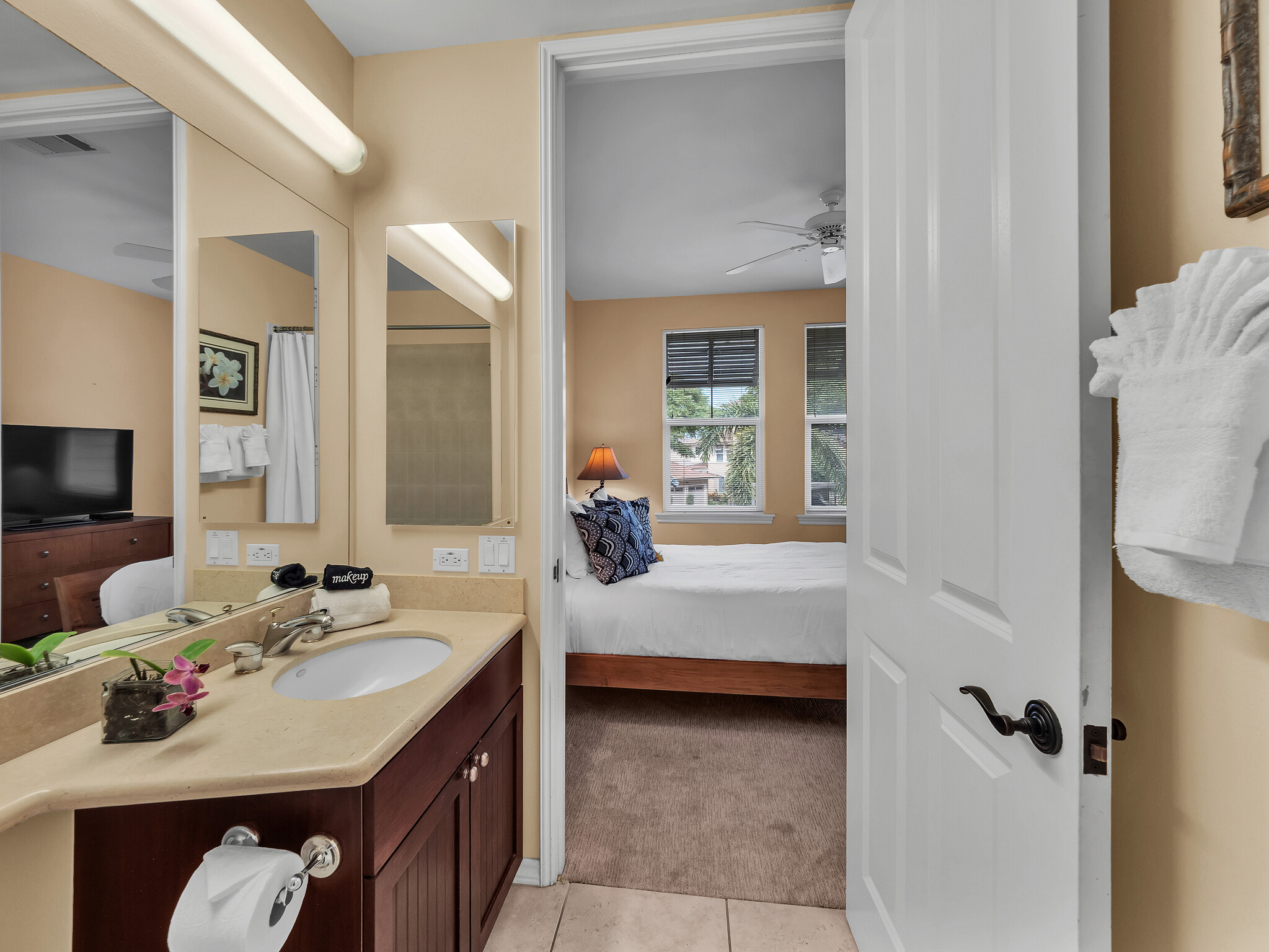 69-200 Pohakulana Place, Unit L4 Waikoloa, HI 96738 - Photo 19 of 29 a en suite bathroom with a double vanity sink a mirror and a bathtub