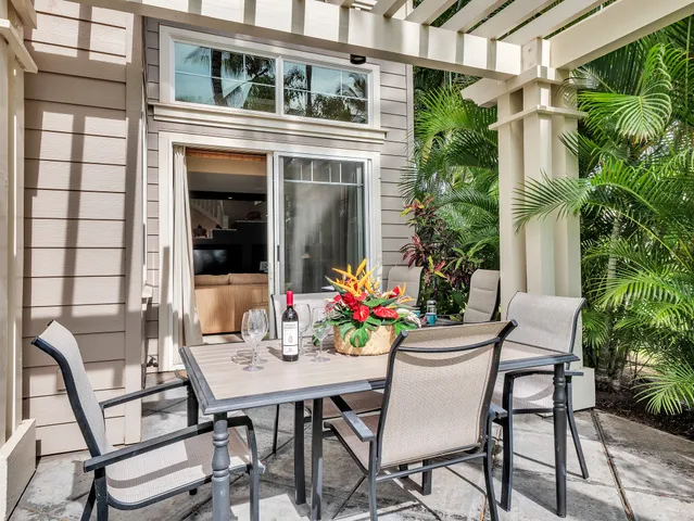 a view of a patio with a table and chairs and potted plants