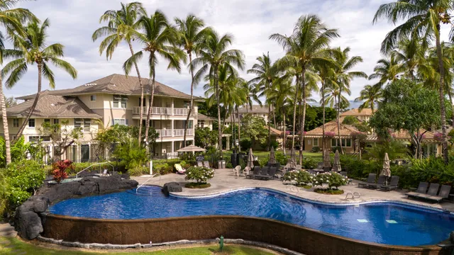 a view of the house with swimming pool and sitting area
