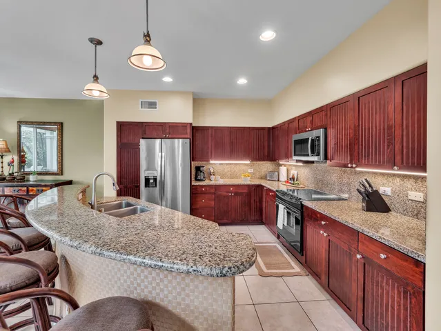 a kitchen with stainless steel appliances granite countertop a sink counter space cabinets and a counter top space