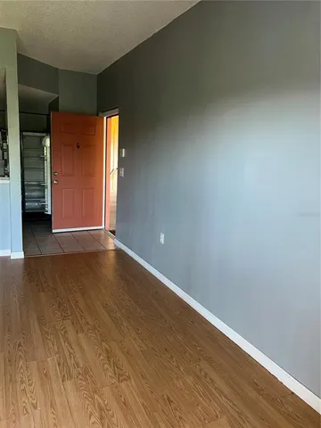 an empty room with wooden floor and closet
