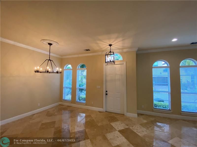 105 Via Floresta Drive Boca Raton, FL 33487 - Photo 4 of 26 a view of a hallway with windows and chandelier