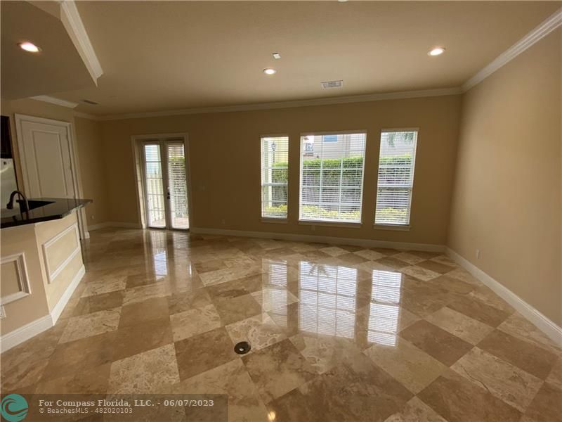 105 Via Floresta Drive Boca Raton, FL 33487 - Photo 10 of 26 a view of an empty room with a fireplace and a window