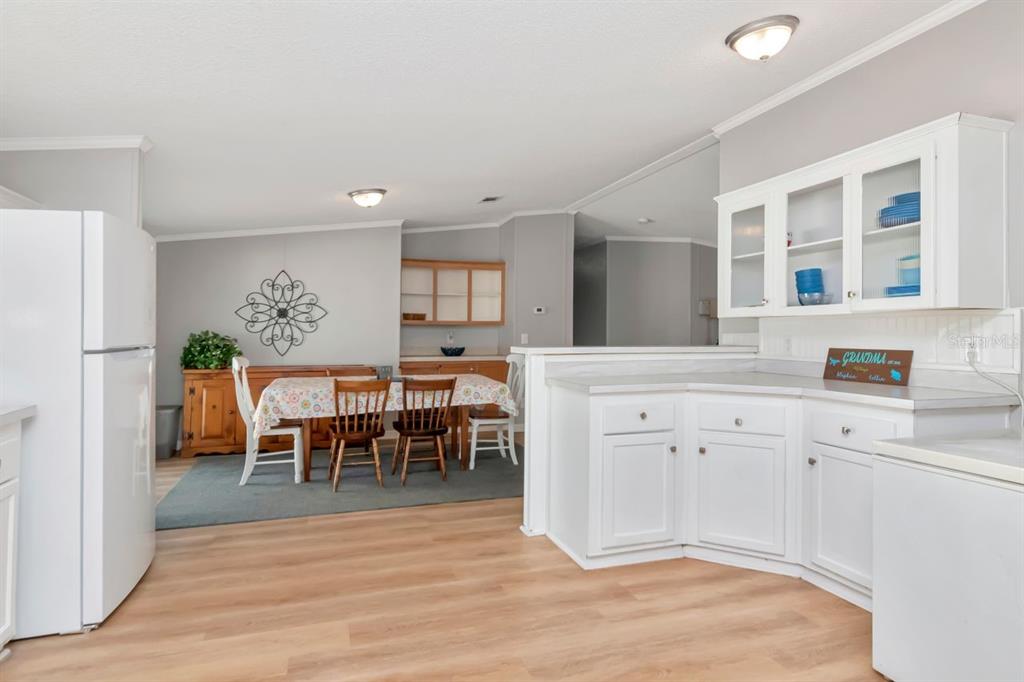 10404 Hawk Court Riverview, FL 33578 - Photo 13 of 38 a open kitchen with stainless steel appliances granite countertop a stove a sink a dining table and chairs with wooden floor