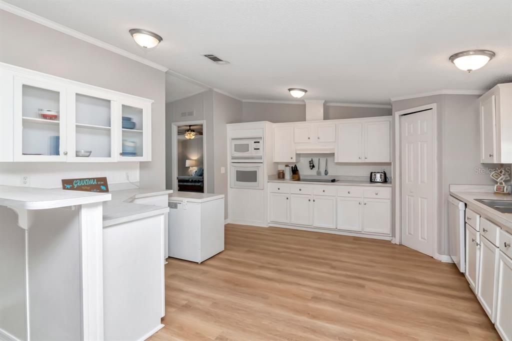 10404 Hawk Court Riverview, FL 33578 - Photo 15 of 38 a large kitchen with cabinets and wooden floor