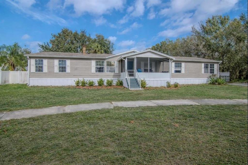 10404 Hawk Court Riverview, FL 33578 - Photo 2 of 38 a front view of a house with a garden