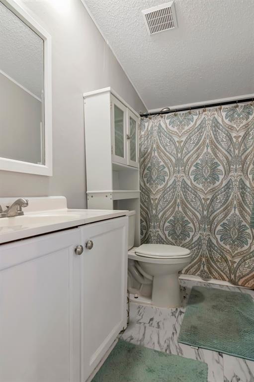 10404 Hawk Court Riverview, FL 33578 - Photo 27 of 38 a bathroom with a sink toilet and shower