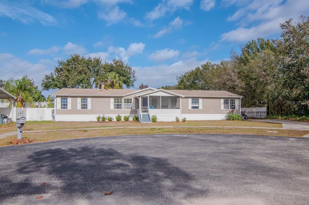10404 Hawk Court Riverview, FL 33578 - Photo 38 of 38 a front view of a house with a garden and trees