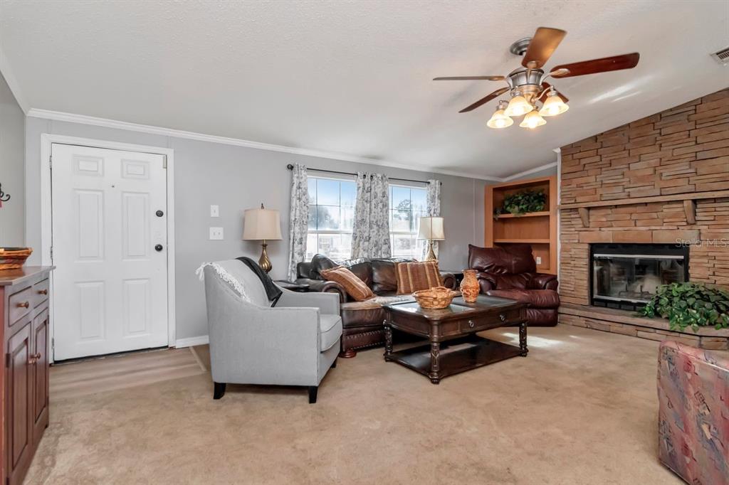 10404 Hawk Court Riverview, FL 33578 - Photo 6 of 38 a living room with furniture and a fireplace