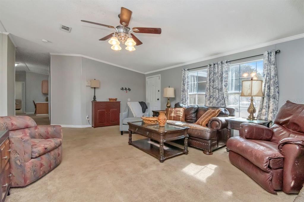 10404 Hawk Court Riverview, FL 33578 - Photo 7 of 38 a living room with furniture and a large window