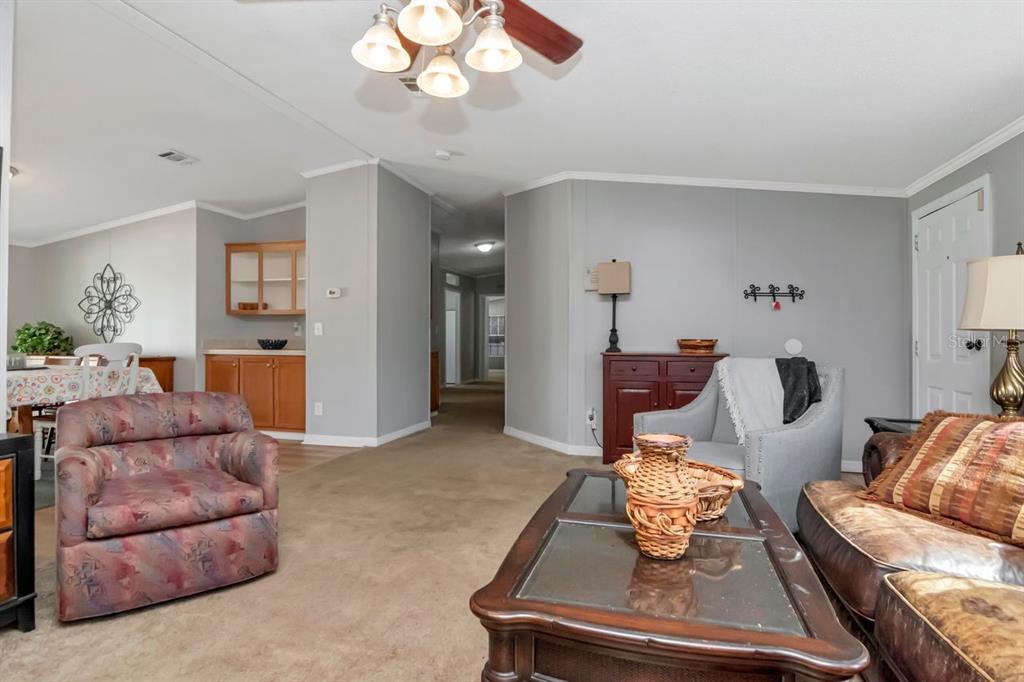 10404 Hawk Court Riverview, FL 33578 - Photo 8 of 38 a living room with furniture and a chandelier