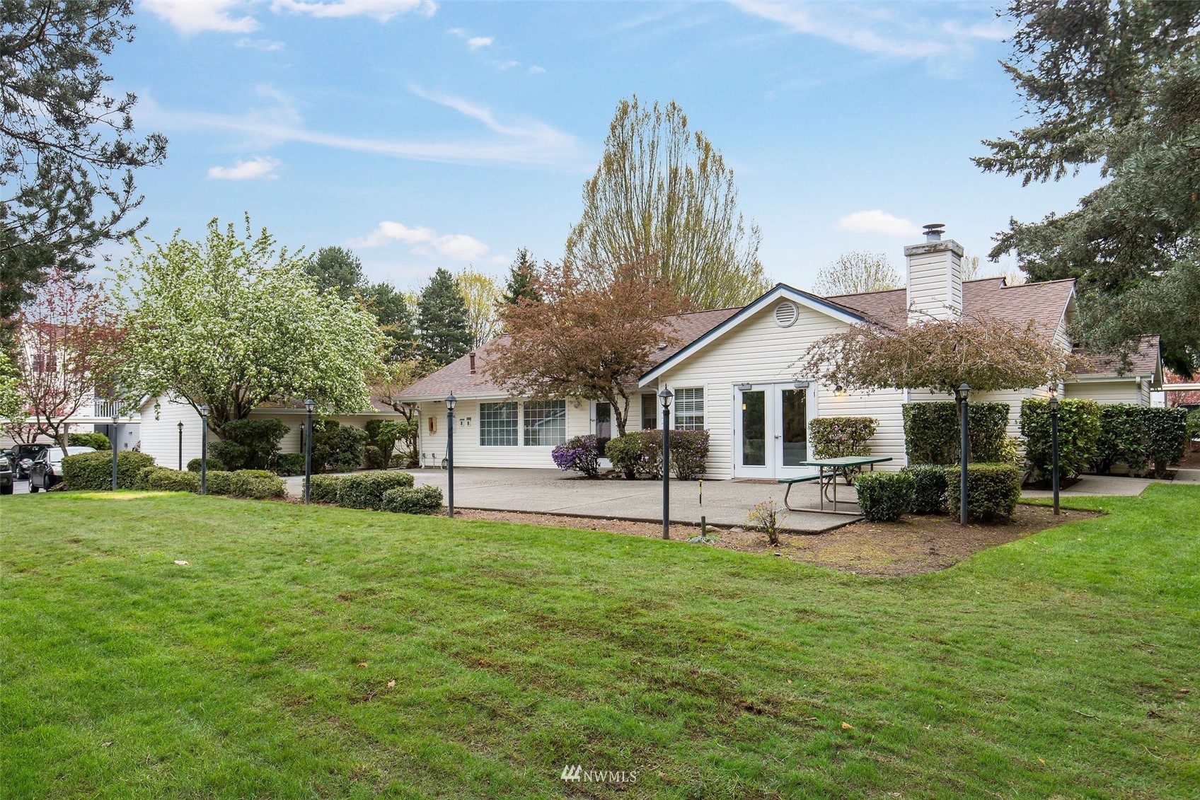 11002 Southeast Petrovitsky Road, Unit C101 Renton, WA 98055 - Photo 22 of 24 a front view of a house with a yard and trees