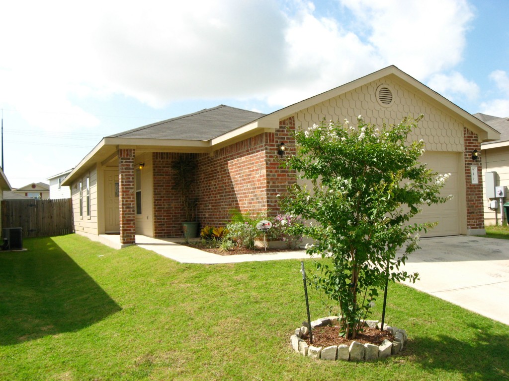 7405 Cayenne Lane Austin, TX 78741 - Photo 1 of 1 a front view of a house with a yard and garage