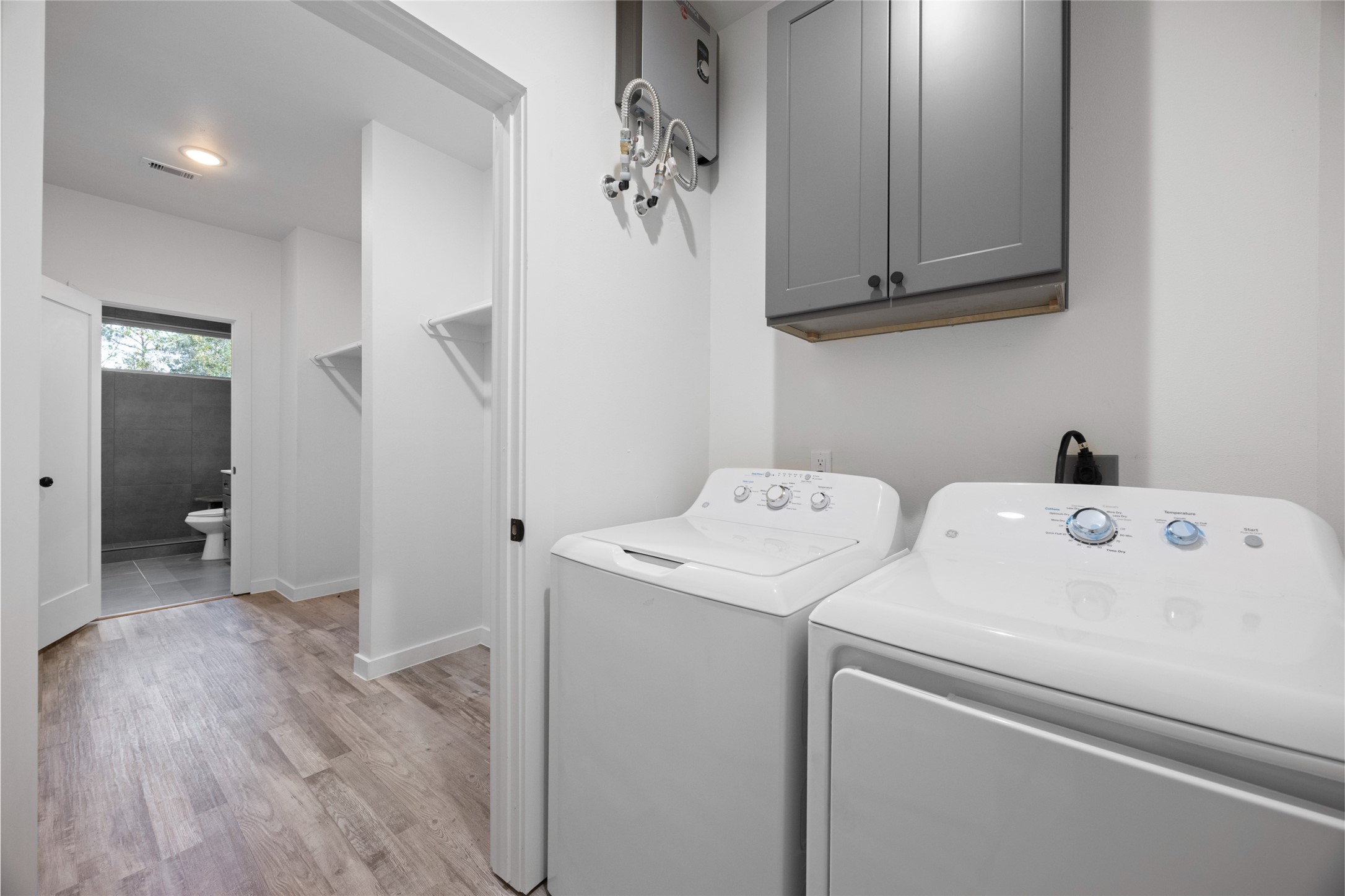 13107 Beauty Berry Ridge Lane Cypress, TX 77429 - Photo 23 of 33 a view of storage and utility room with washer and dryer