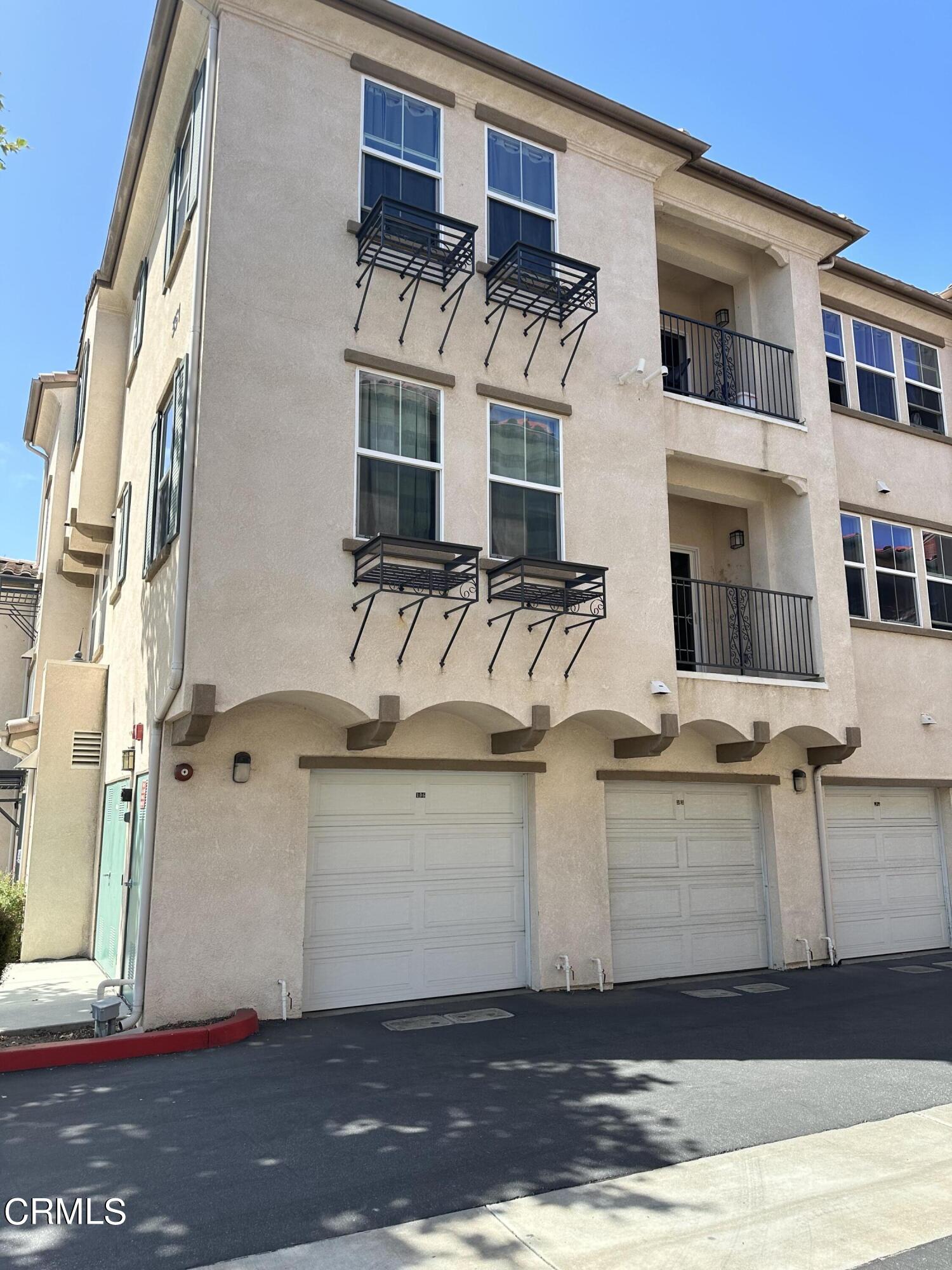 a view of a white building with large windows