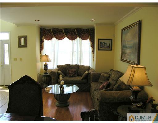 46 Lexington Road Monmouth Junction, NJ 08852 - Photo 3 of 10 a living room with furniture and a lamp