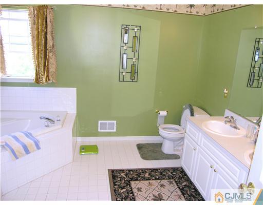 46 Lexington Road Monmouth Junction, NJ 08852 - Photo 8 of 10 a bathroom with a sink and a toilet