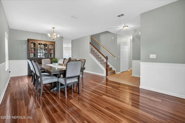 a view of a dining room with furniture and wooden floor