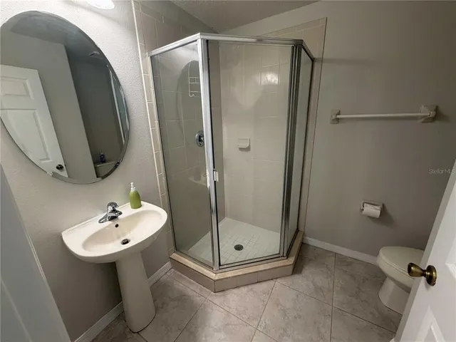 a bathroom with a sink a mirror and a shower