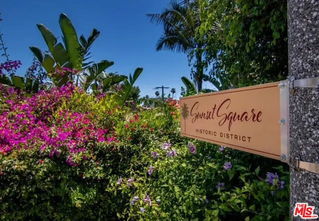 a sign in front of flowers