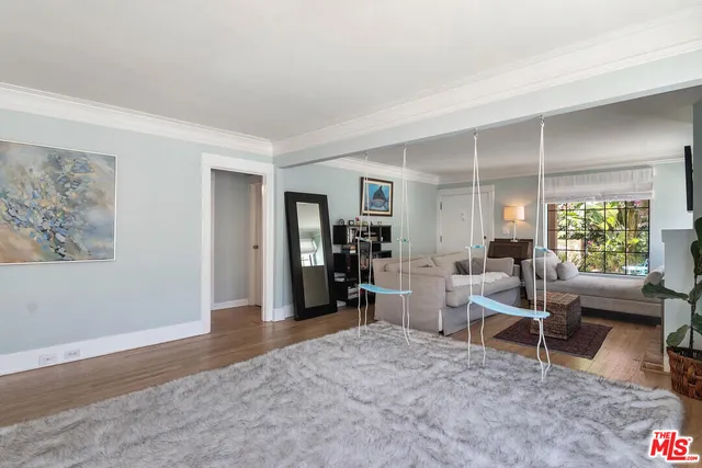 a living room with furniture window and wooden floor