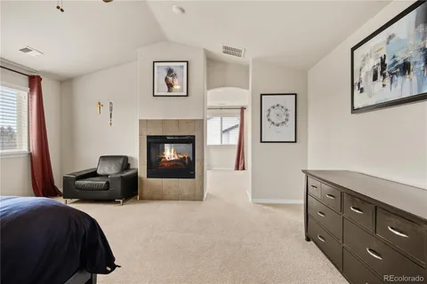 a bedroom with a bed and a fireplace