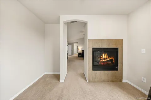 a view of an empty room with a fireplace