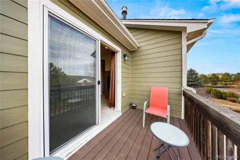 a balcony with table and chairs