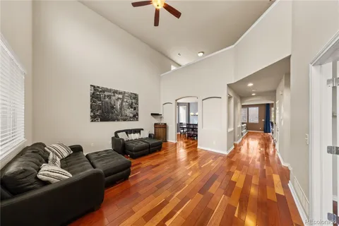 a living room with furniture and a wooden floor