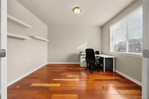 a view of a workspace with furniture and a window